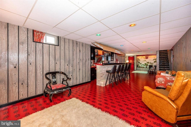7198 Allegheny Dr, Frederick, MD 21702 - interior space featuring wood walls, stairs, a paneled ceiling, a bar, and carpet