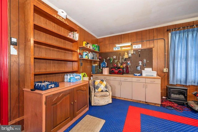 7198 Allegheny Dr, Frederick, MD 21702 - interior space with crown molding, a wood stove, wooden walls, and carpet flooring