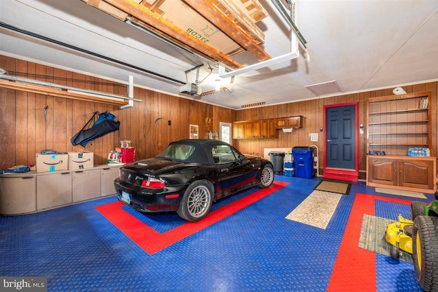 7198 Allegheny Dr, Frederick, MD 21702 - garage with a garage door opener and wood walls