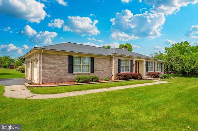 7198 Allegheny Dr, Frederick, MD 21702 - view of front of house featuring a chimney, a front yard, brick siding, aphalt driveway, and an attached garage