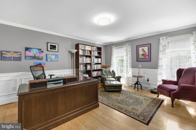 home office featuring a wainscoted wall, a decorative wall, and crown molding