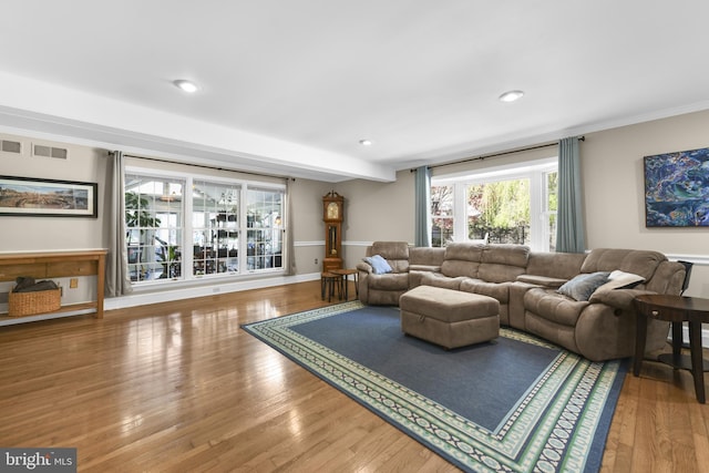 living room with wood finished floors, visible vents, recessed lighting, and crown molding