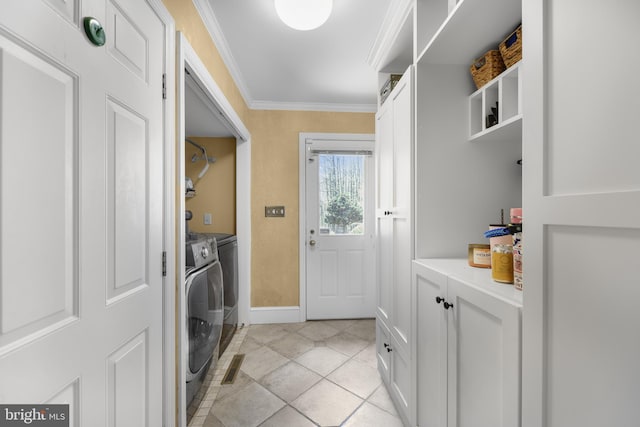 laundry room featuring washer and clothes dryer, light tile patterned flooring, baseboards, laundry area, and ornamental molding