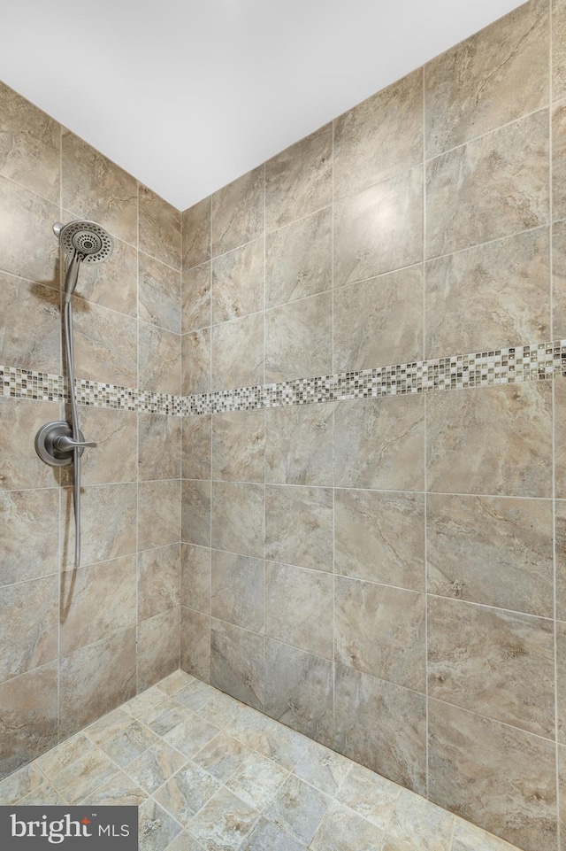 full bath with a tile shower