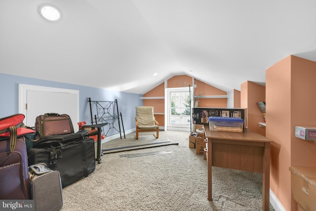 interior space featuring baseboards, lofted ceiling, and carpet