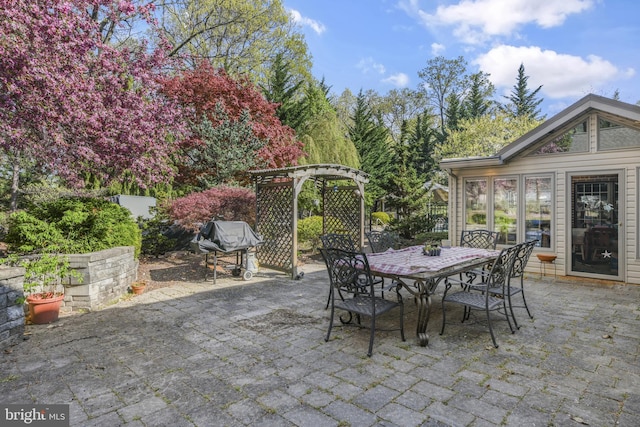 view of patio with a grill and outdoor dining space