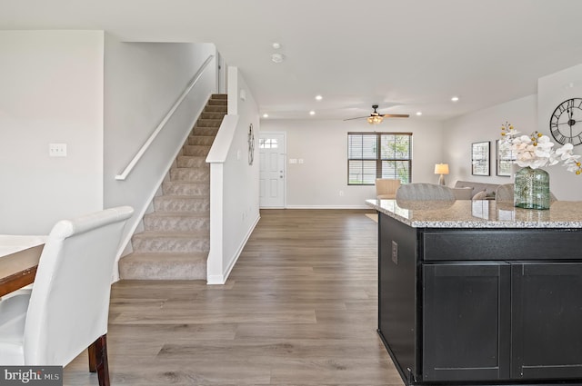 kitchen with dark cabinets, baseboards, recessed lighting, ceiling fan, and wood finished floors