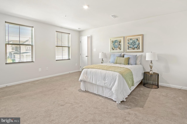 bedroom with baseboards, visible vents, and carpet floors