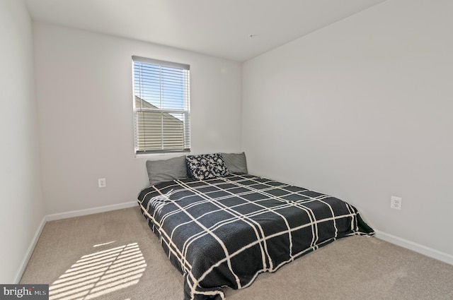 bedroom with baseboards and carpet