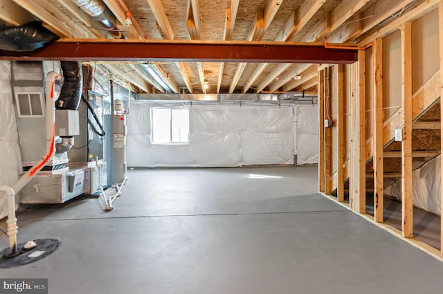 basement with electric water heater and visible vents