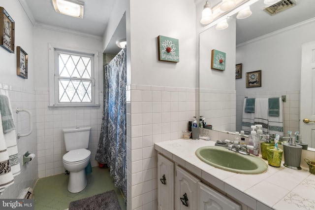 bathroom with visible vents, toilet, tile walls, vanity, and tile patterned flooring