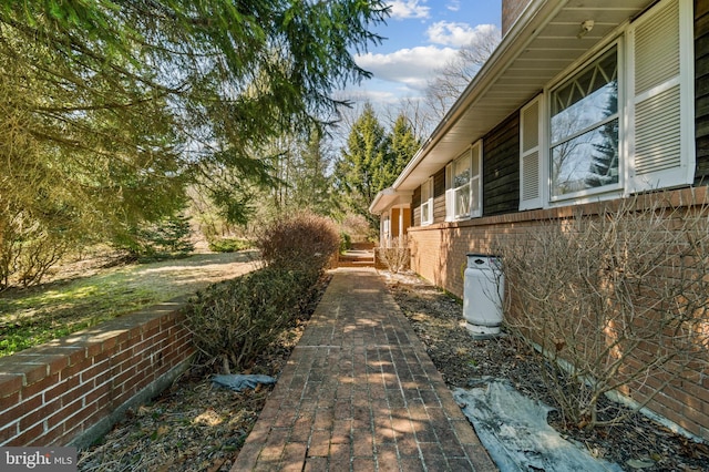 view of side of home featuring brick siding