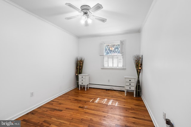 unfurnished room with crown molding, wood-type flooring, a baseboard radiator, and ceiling fan