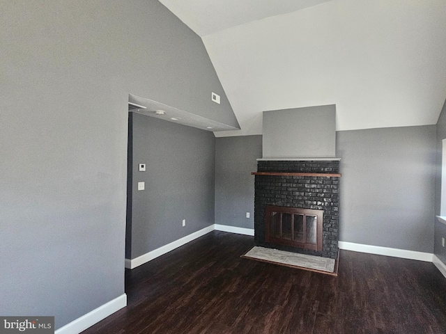 unfurnished living room with visible vents, baseboards, a fireplace, wood finished floors, and high vaulted ceiling