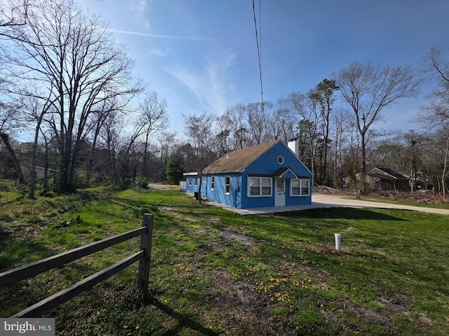 rear view of house with a lawn and a chimney