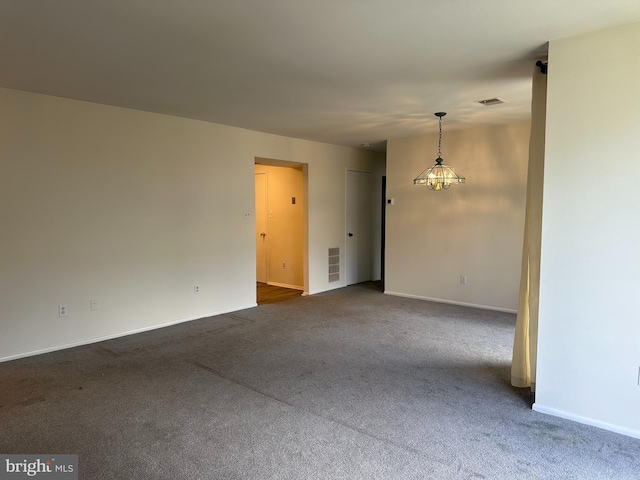 10206 Prince Pl Unit 4-204, Upper Marlboro, MD 20774 - empty room featuring an inviting chandelier, visible vents, dark colored carpet, and baseboards