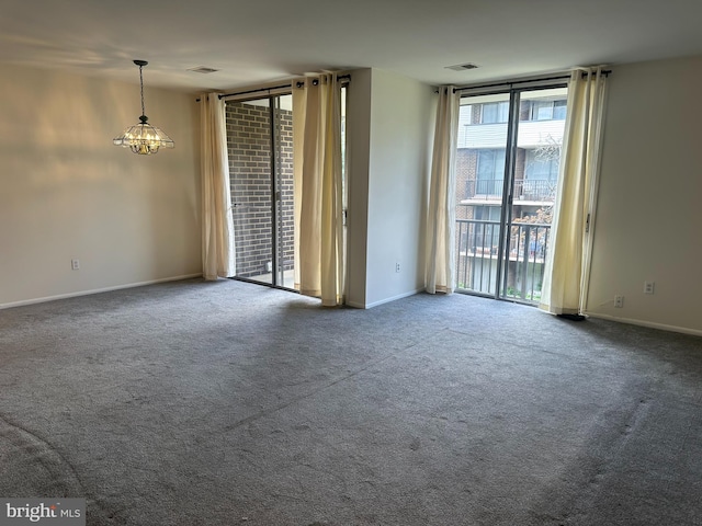 10206 Prince Pl Unit 4-204, Upper Marlboro, MD 20774 - carpeted spare room with visible vents, baseboards, a notable chandelier, and expansive windows