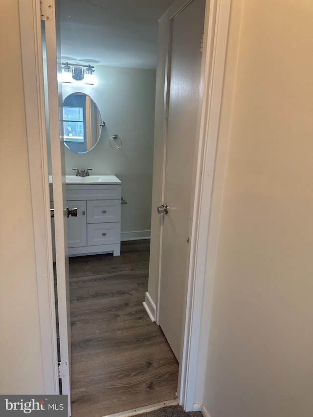 10206 Prince Pl Unit 4-204, Upper Marlboro, MD 20774 - hallway with dark wood-style flooring, baseboards, and a sink