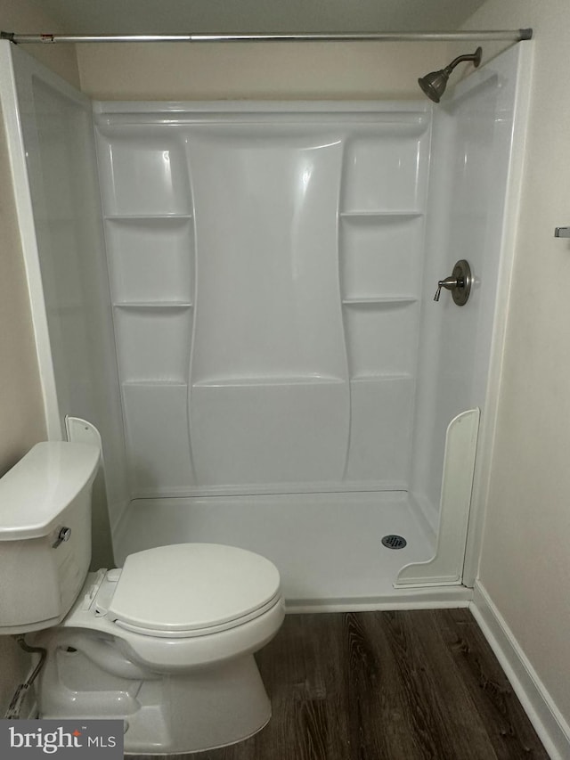 10206 Prince Pl Unit 4-204, Upper Marlboro, MD 20774 - bathroom featuring toilet, a shower stall, wood finished floors, and baseboards