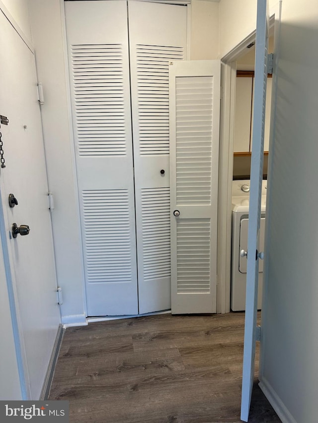 10206 Prince Pl Unit 4-204, Upper Marlboro, MD 20774 - washroom with washer / dryer, dark wood-style flooring, baseboards, and cabinet space