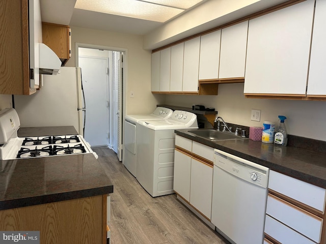 10206 Prince Pl Unit 4-204, Upper Marlboro, MD 20774 - laundry area with a sink, light wood-type flooring, washing machine and dryer, and laundry area