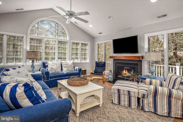 living room with a fireplace with flush hearth, ceiling fan, visible vents, and recessed lighting