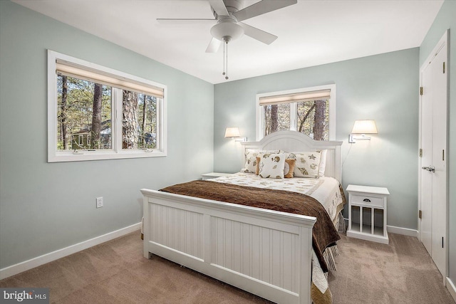 carpeted bedroom with baseboards and ceiling fan