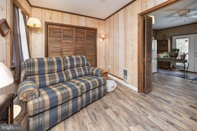 1036 S Schumaker Dr, Salisbury, MD 21804 - sitting room featuring wood walls, heating unit, wood finished floors, a ceiling fan, and crown molding
