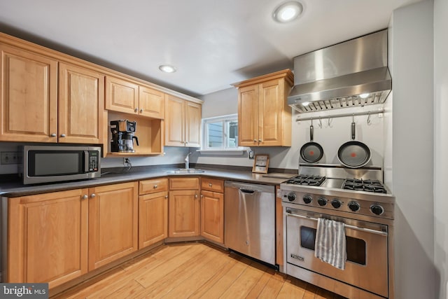 935 S Kenwood Ave, Baltimore, MD 21224 - kitchen featuring a sink, wall chimney exhaust hood, light wood-style flooring, dark countertops, and appliances with stainless steel finishes