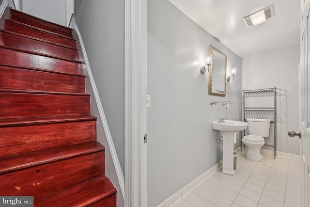 935 S Kenwood Ave, Baltimore, MD 21224 - stairs featuring baseboards, visible vents, and tile patterned floors