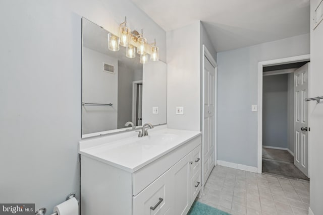 935 S Kenwood Ave, Baltimore, MD 21224 - bathroom featuring vanity, baseboards, visible vents, tile patterned flooring, and a notable chandelier