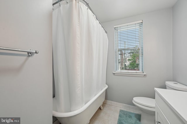 935 S Kenwood Ave, Baltimore, MD 21224 - full bathroom featuring toilet, a tub to relax in, a shower with shower curtain, tile patterned flooring, and vanity