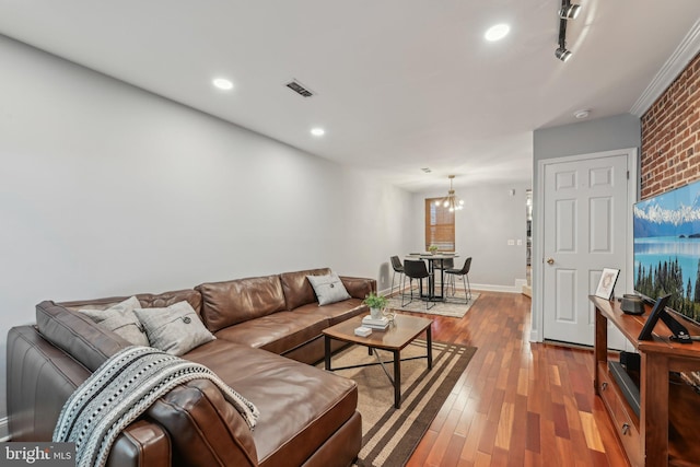 935 S Kenwood Ave, Baltimore, MD 21224 - living area with wood finished floors, baseboards, visible vents, recessed lighting, and a notable chandelier