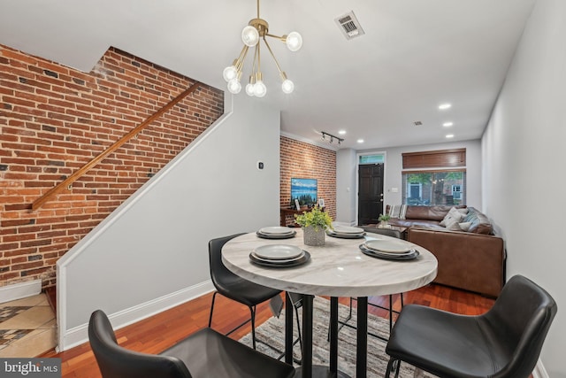 935 S Kenwood Ave, Baltimore, MD 21224 - dining room with baseboards, brick wall, and visible vents