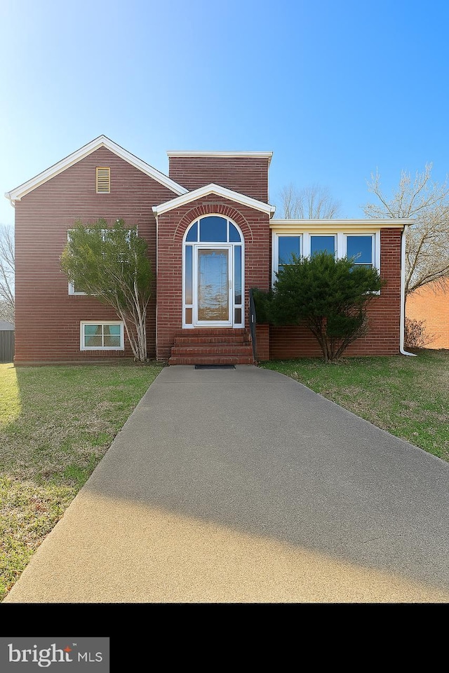 5608 1st St NE, Washington, DC 20011 - view of front of house featuring a front yard, brick siding, and entry steps