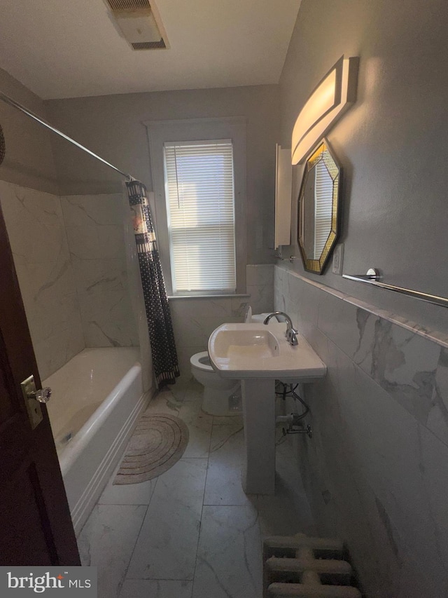 5608 1st St NE, Washington, DC 20011 - full bath featuring tile walls, toilet, visible vents, wainscoting, and marble finish floor