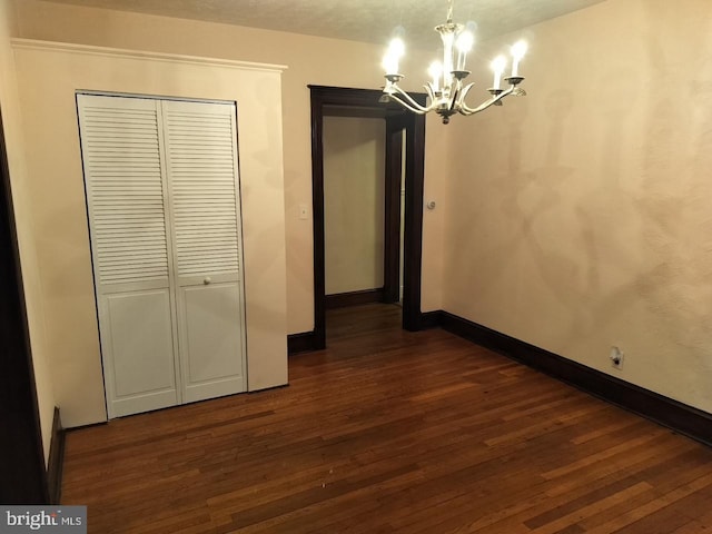 5608 1st St NE, Washington, DC 20011 - unfurnished dining area featuring a chandelier, baseboards, and dark wood finished floors