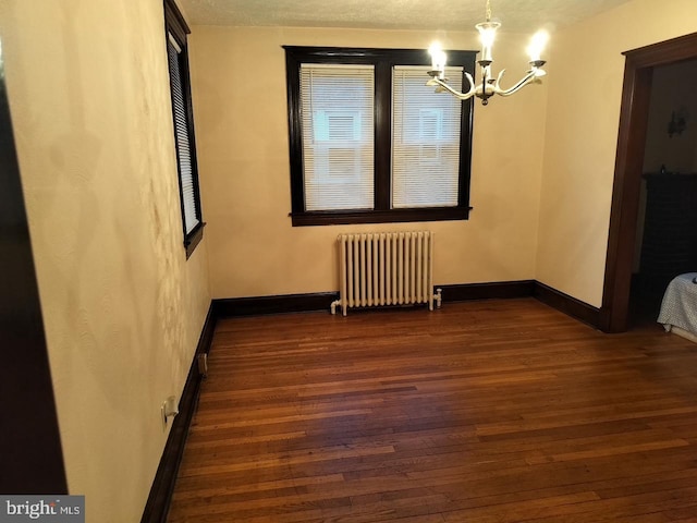 5608 1st St NE, Washington, DC 20011 - unfurnished dining area featuring baseboards, an inviting chandelier, radiator, and wood finished floors