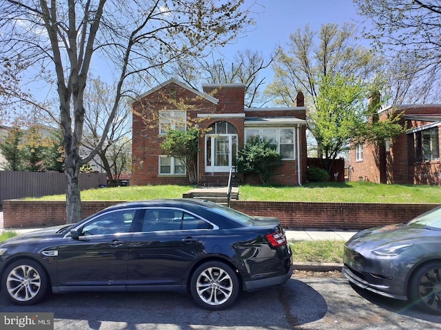 5608 1st St NE, Washington, DC 20011 - view of front of house with entry steps, a front yard, fence, and brick siding