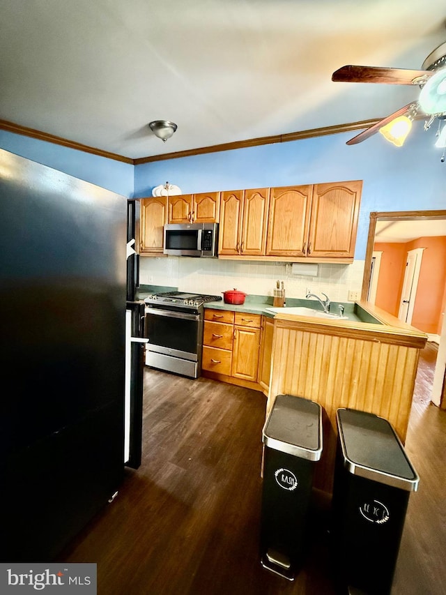 200 E Pacific Ave, Minotola, NJ 08341 - kitchen featuring appliances with stainless steel finishes, dark wood-type flooring, backsplash, crown molding, and a ceiling fan