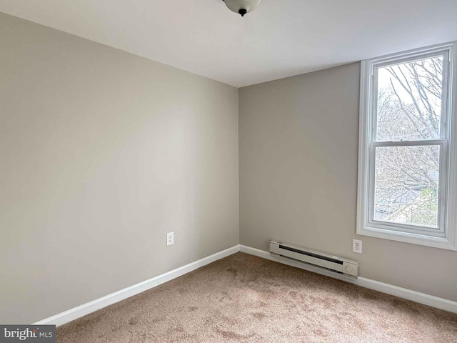 carpeted empty room featuring baseboards and a baseboard radiator