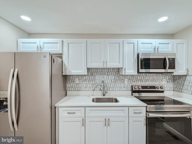 1324 W Pratt St, Baltimore, MD 21223 - kitchen with appliances with stainless steel finishes, tasteful backsplash, white cabinets, and recessed lighting
