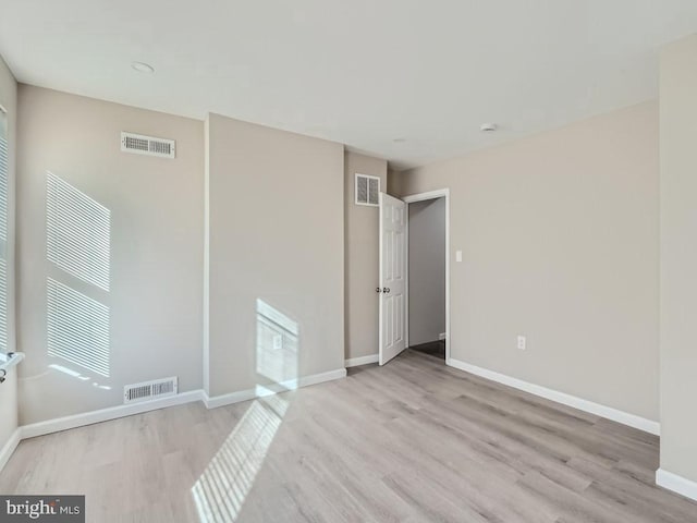 1324 W Pratt St, Baltimore, MD 21223 - unfurnished room featuring wood finished floors and healthy amount of natural light