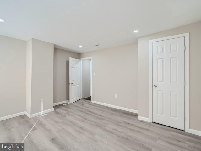 1324 W Pratt St, Baltimore, MD 21223 - empty room featuring light wood-style flooring and recessed lighting