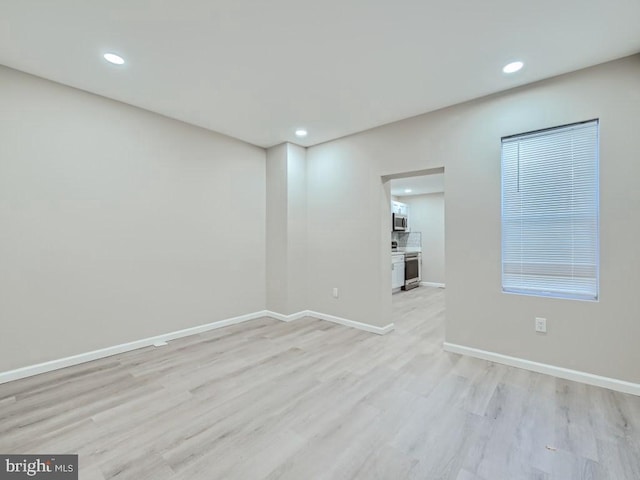 1324 W Pratt St, Baltimore, MD 21223 - empty room featuring light wood-type flooring and recessed lighting