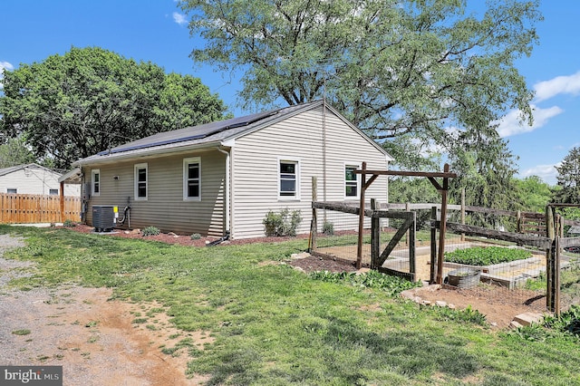 13 Ash Dr, Knoxville, MD 21758 - view of side of property featuring a lawn, fence, solar panels, and a garden