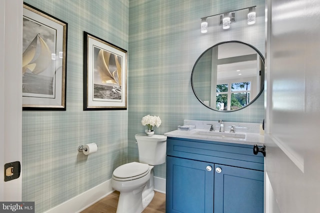938A Benning Rd, Galesville, MD 20765 - bathroom with vanity, baseboards, wallpapered walls, toilet, and wood finished floors