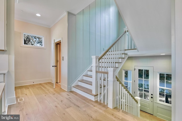 938A Benning Rd, Galesville, MD 20765 - staircase with ornamental molding, visible vents, wood finished floors, french doors, and baseboards