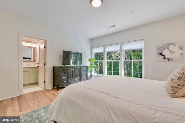 938A Benning Rd, Galesville, MD 20765 - bedroom featuring visible vents, light wood-style flooring, ensuite bath, and baseboards