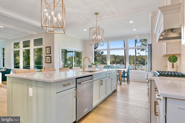 938A Benning Rd, Galesville, MD 20765 - kitchen with a center island with sink, appliances with stainless steel finishes, light wood finished floors, and a notable chandelier